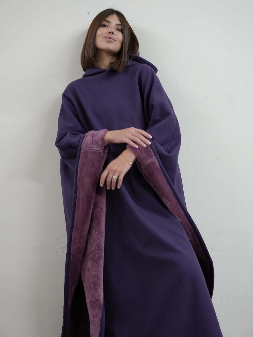 Woman wearing the Eden Comfort Hoodie Blanket in purple, promoting relaxation and stress relief.