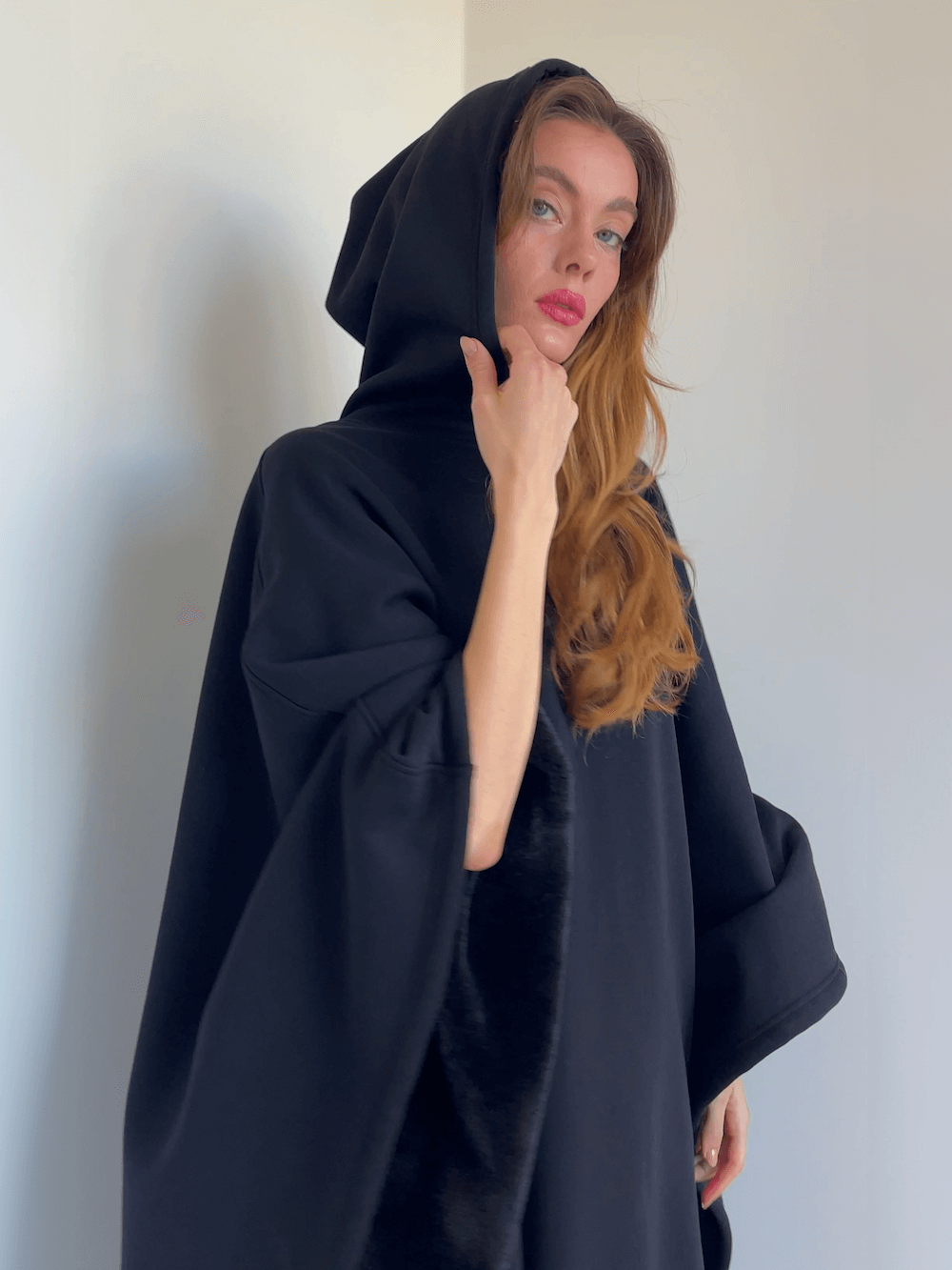 Woman wearing an Eden Comfort Hoodie Blanket, showcasing comfort, style, and relaxation features.